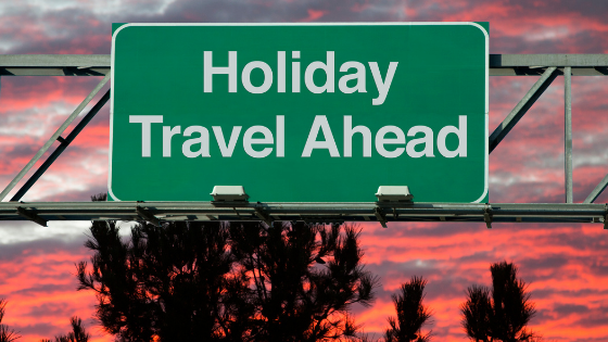 Holiday travel ahead sign on a highway.
