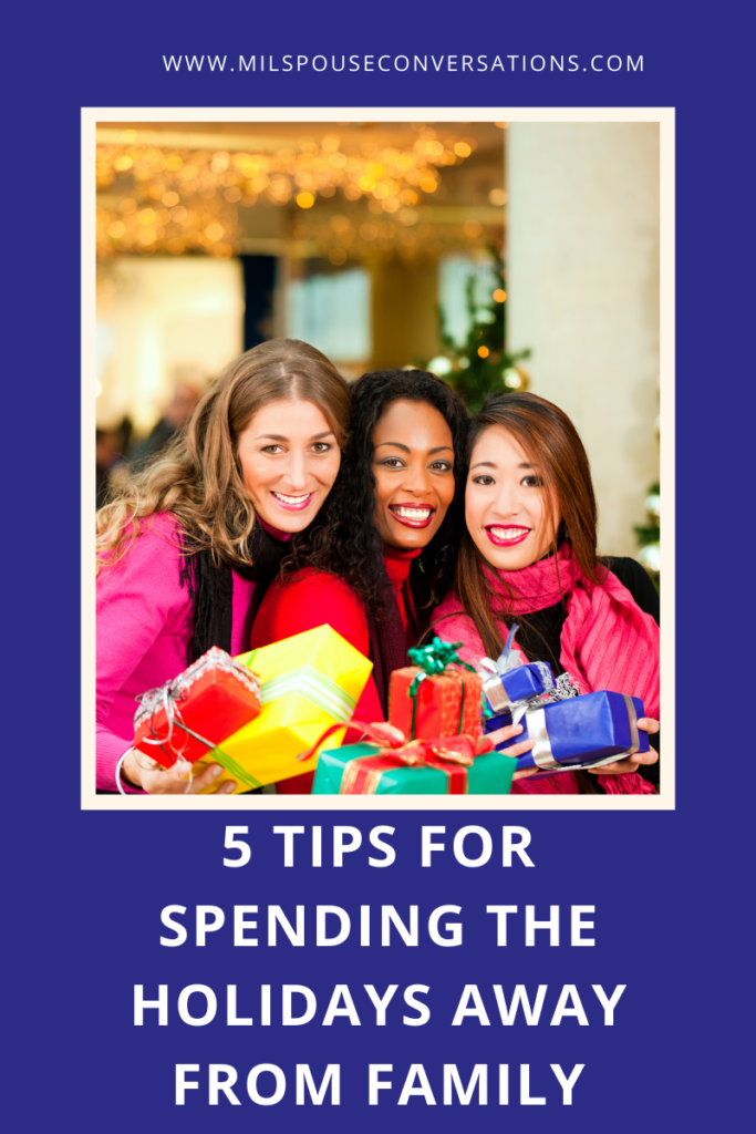 A group of women holding gifts in front of a christmas tree.