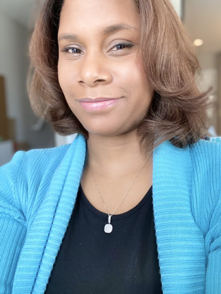 A woman in blue jacket and black shirt.