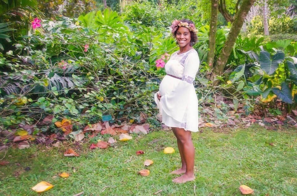 A woman in white dress standing on grass.