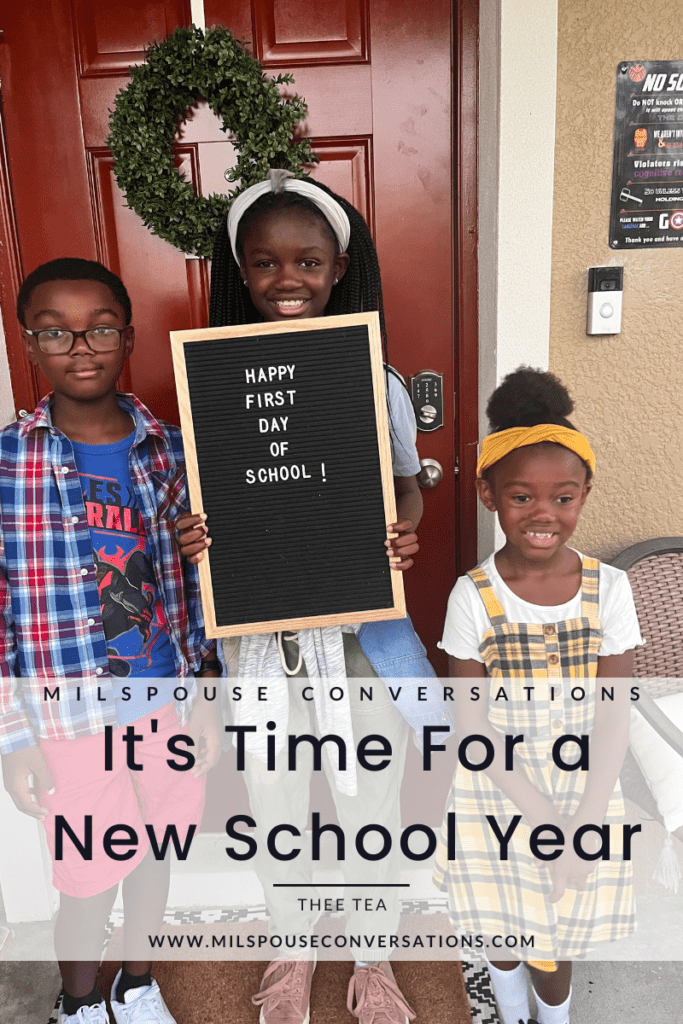 Three children holding a sign that says it's time for a new school year.