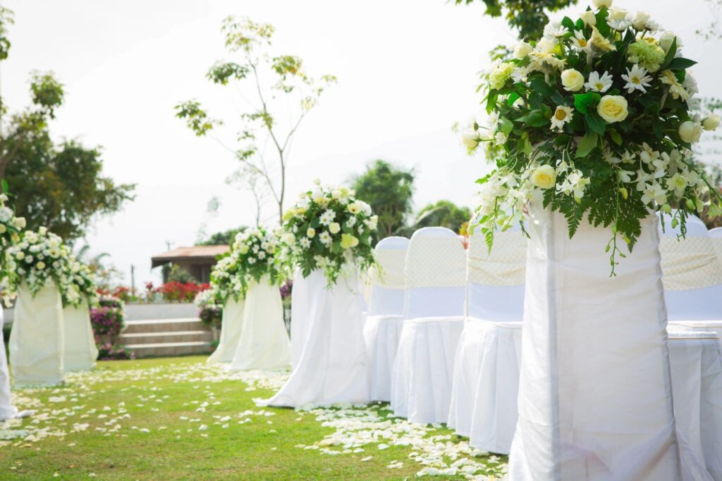 A white chair and table with flowers on top of it.
