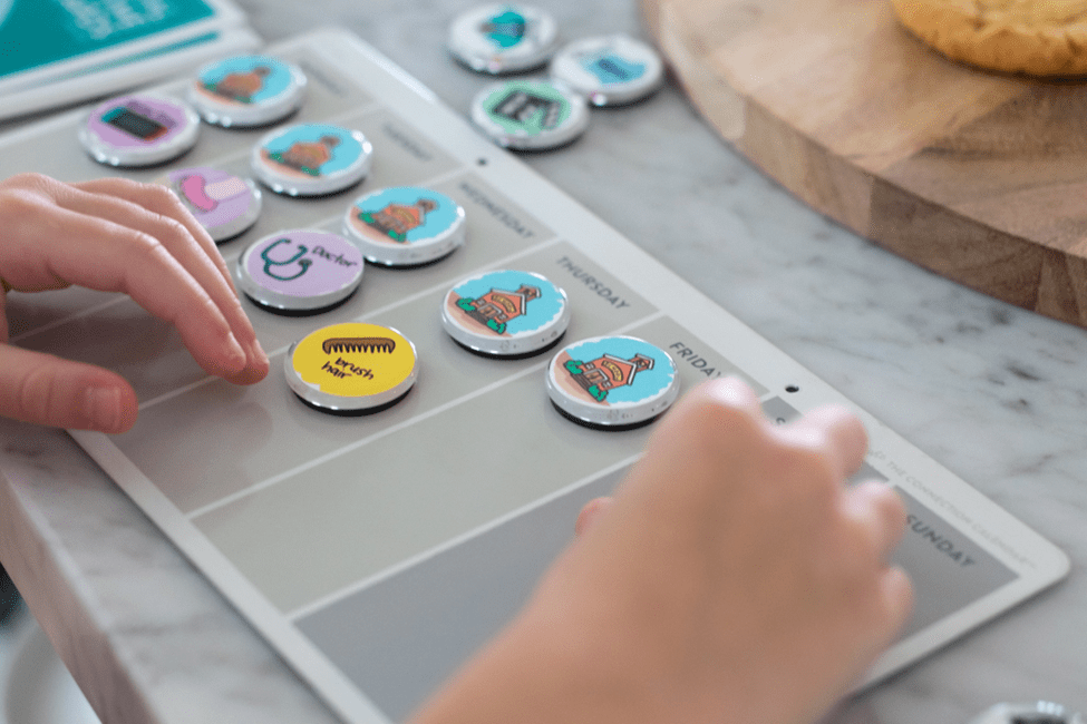 A person playing with buttons on the board